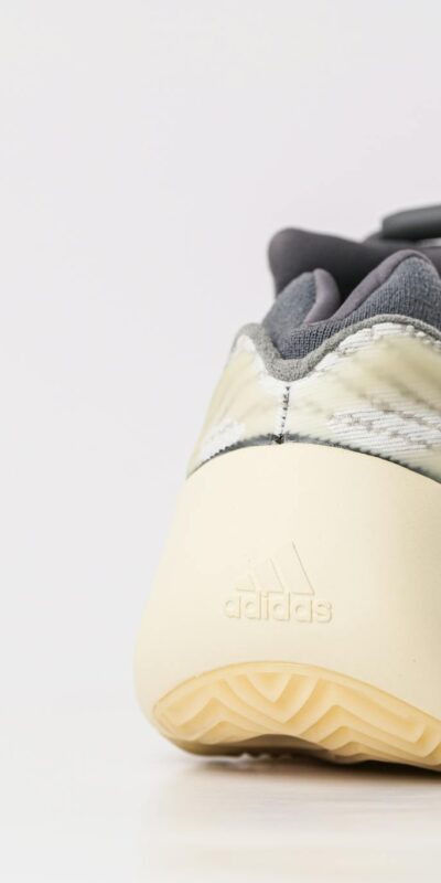 Close-up of a stylish sports sneaker on a white surface, showcasing modern design.