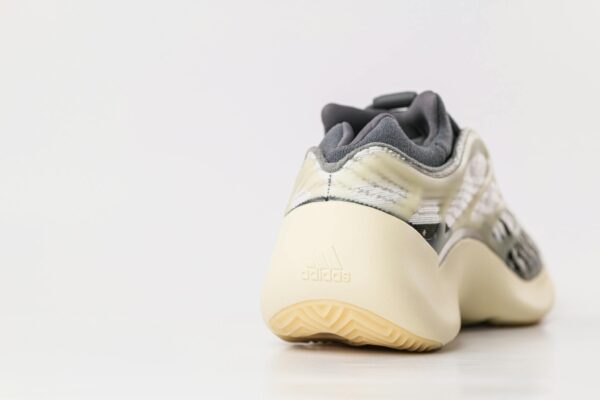 Close-up of a stylish sports sneaker on a white surface, showcasing modern design.